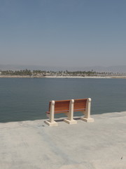 Empty wooden bench overlooking the sea
