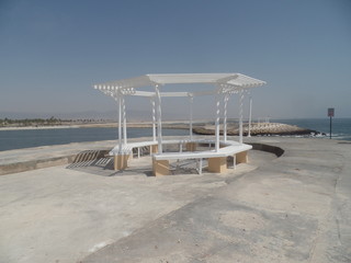 White bandstand on a pier overlooking the sea