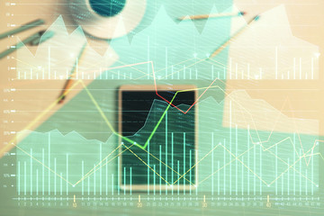 Double exposure of forex graph on digital tablet laying on table background. Concept of market analysis