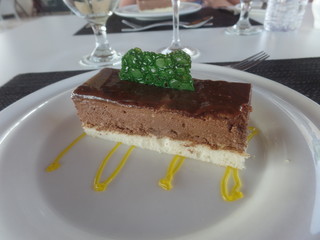 Chocolate dessert served with passion fruit coulis