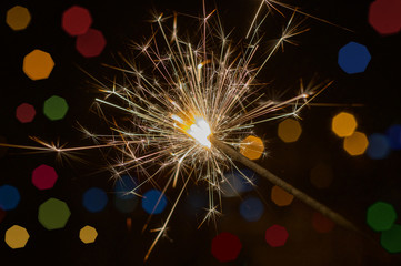 sparkler on a background of night bokeh