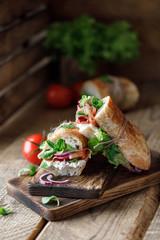 Fresh sandwich with tomatoes, jamon, corn salad and philadelphia cheese
