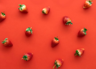 Minimal polka dot fresh strawberries on red background