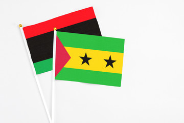 Sao Tome And Principe and Libya stick flags on white background. High quality fabric, miniature national flag. Peaceful global concept.White floor for copy space.