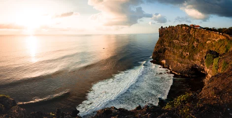 Gordijnen Beautiful Panoramic view of an Iconic Famous Place, Uluwatu Temple, during a vibrant summer sunrise. Located in Bali, Indonesia  © Pavel Kašák