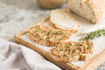 Fresh homemade chicken liver pate. Chicken liver pate on bread and in jar on a light background