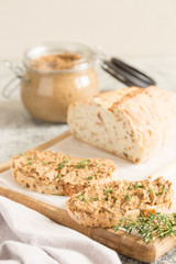 Fresh homemade chicken liver pate. Chicken liver pate on bread and in jar on a light background