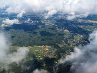 Clouds above the ground view from an airplane as a background