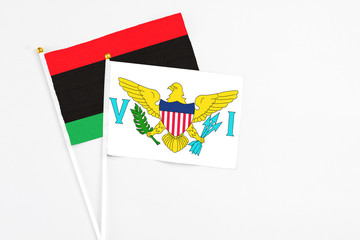 United States Virgin Islands and Libya stick flags on white background. High quality fabric, miniature national flag. Peaceful global concept.White floor for copy space.