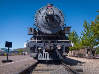 Fototapeten Williams, Arizona USA: Steam locomotive train in the city on Historic Route 66, south terminus of Grand Canyon Railway. © arkanto