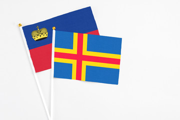 Aland Islands and Liechtenstein stick flags on white background. High quality fabric, miniature...