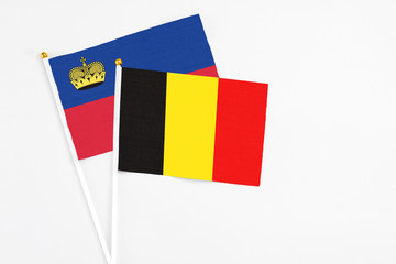 Belgium and Liechtenstein stick flags on white background. High quality fabric, miniature national flag. Peaceful global concept.White floor for copy space.