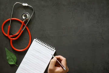 Background medical concept. Cardiologist's table. A stethoscope and medicine are prescribed by a doctor.