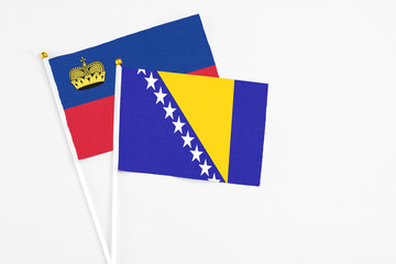 Bosnia Herzegovina and Liechtenstein stick flags on white background. High quality fabric,...