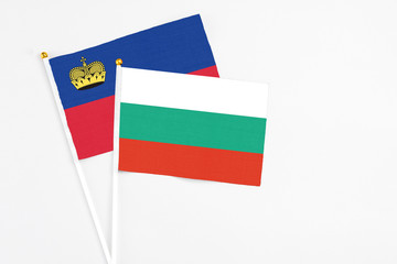Bulgaria and Liechtenstein stick flags on white background. High quality fabric, miniature national flag. Peaceful global concept.White floor for copy space.