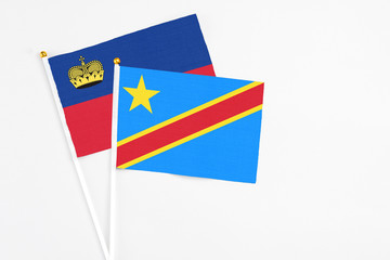 Congo and Liechtenstein stick flags on white background. High quality fabric, miniature national flag. Peaceful global concept.White floor for copy space.
