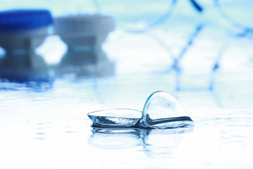 Tools for vision correction. Glasses and lenses with diopters on the background of splashes and...