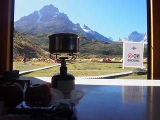 Magnificent mountains reflected in the background with a small portable camping gas stove, Torres...
