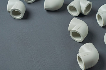 Scattered polypropylene, plastic corners of 90 degree for connecting pipe for water or other liquid...