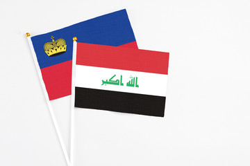 Iraq and Liechtenstein stick flags on white background. High quality fabric, miniature national flag. Peaceful global concept.White floor for copy space.