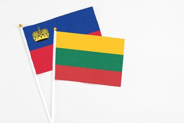 Lithuania and Liechtenstein stick flags on white background. High quality fabric, miniature national flag. Peaceful global concept.White floor for copy space.