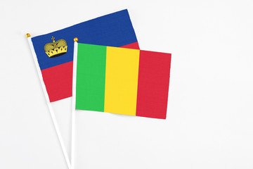 Mali and Liechtenstein stick flags on white background. High quality fabric, miniature national flag. Peaceful global concept.White floor for copy space.