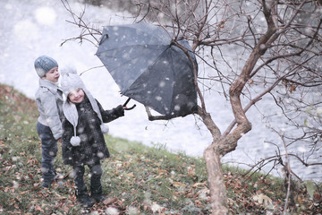 Kids walk in the park first snow