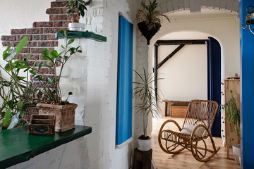 Interior of aprtment with wooden floor ,bricks on the wall , blue casing in greek style. Cozy and...