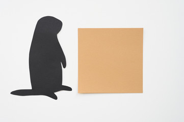 Groundhog day. Groundhog silhouette cut from black paper and brown blank sticker writing paper on white background. Space for text