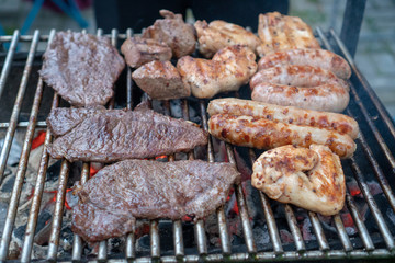 close-up Assorted delicious grilled meat and bratwurst  over the coals on a barbecue