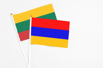 Armenia and Lithuania stick flags on white background. High quality fabric, miniature national flag. Peaceful global concept.White floor for copy space.