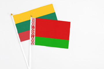 Belarus and Lithuania stick flags on white background. High quality fabric, miniature national flag. Peaceful global concept.White floor for copy space.