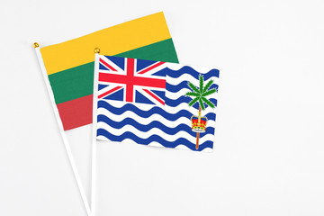Fototapeta premium British Indian Ocean Territory and Lithuania stick flags on white background. High quality fabric, miniature national flag. Peaceful global concept.White floor for copy space.