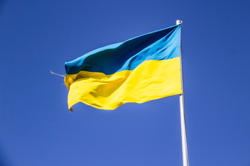 A Ukrainian flag in the blue sky