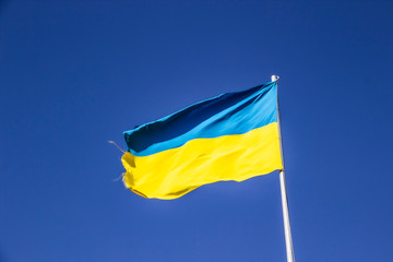 A Ukrainian flag in the blue sky