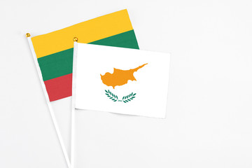 Cyprus and Lithuania stick flags on white background. High quality fabric, miniature national flag. Peaceful global concept.White floor for copy space.