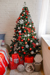 Beautiful holiday decorated room with Christmas tree with presents under it