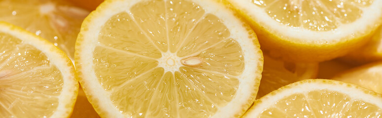 close up view of ripe fresh yellow lemon slices, panoramic shot