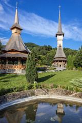 Fototapeta na wymiar Summer altar and wooden church in famous Barsana Monastery in Maramures region in Romania