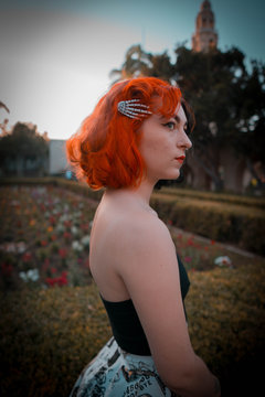 portrait of a young rockabilly model looking to her right in a garden