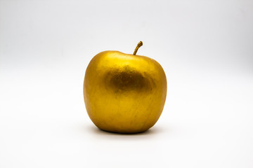 A golden apple on a white background