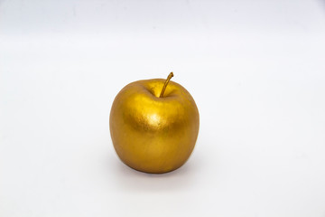 A golden apple on a white background