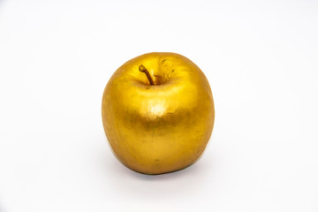 A golden apple on a white background. Business concepts