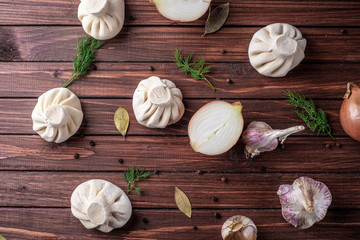 Georgian khinkali dumplings with meat, onion and garlic in the layout on the cutting Board