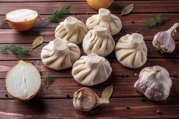 Georgian khinkali dumplings with meat, onion and garlic in the layout on the cutting Board