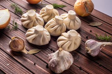 Georgian khinkali dumplings with meat, onion and garlic in the layout on the cutting Board