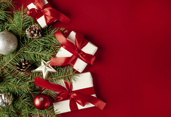 Christmas card with Christmas tree and gifts on a red background. with a place for congratulations.