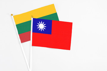 Taiwan and Lithuania stick flags on white background. High quality fabric, miniature national flag. Peaceful global concept.White floor for copy space.