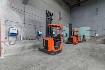 forklift charging in the warehouse © gluschenkoart