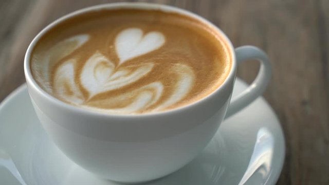 hot latte coffee on wood table